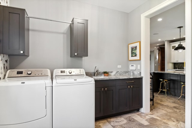 laundry room with a sink, cabinet space, separate washer and dryer, and recessed lighting