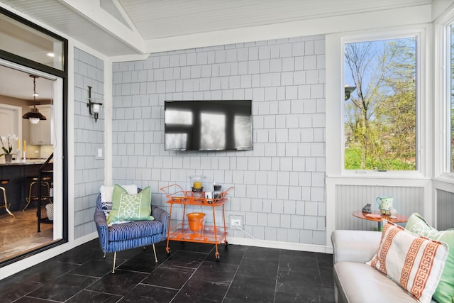 sitting room with tile patterned flooring and tile walls