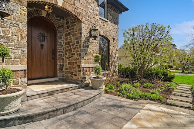 doorway to property featuring stone siding