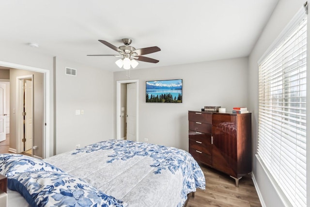 bedroom featuring visible vents, wood finished floors, and a ceiling fan
