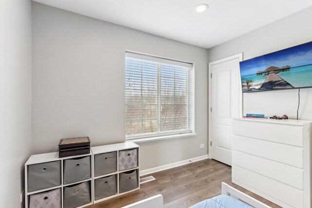 unfurnished bedroom with baseboards, visible vents, and wood finished floors