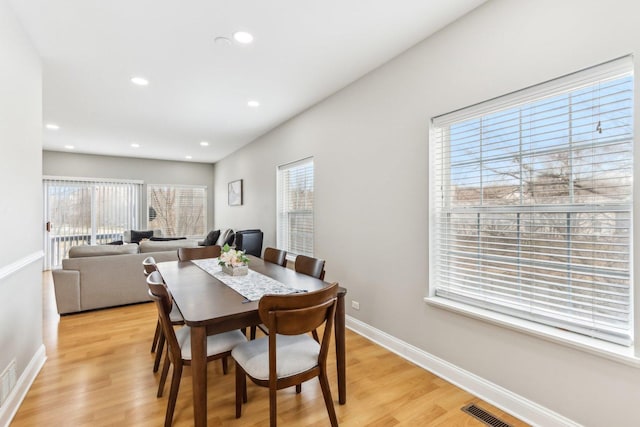 dining area with baseboards, recessed lighting, and light wood-style floors