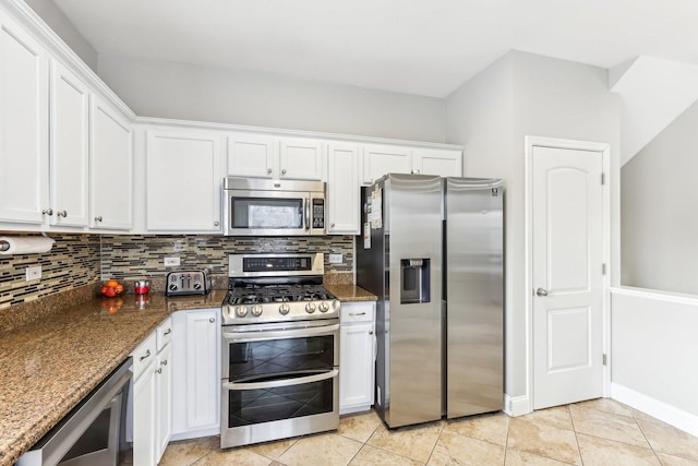 kitchen featuring white cabinets, dark stone countertops, backsplash, and stainless steel appliances