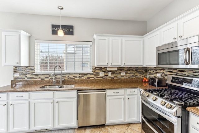 kitchen featuring white cabinets, a sink, tasteful backsplash, and appliances with stainless steel finishes