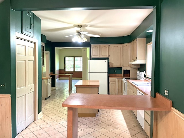 kitchen with under cabinet range hood, light countertops, a peninsula, white appliances, and a ceiling fan