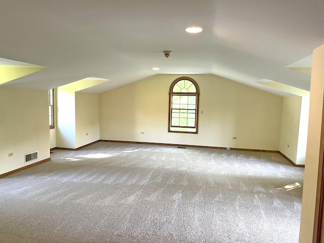 bonus room with visible vents, baseboards, carpet, and lofted ceiling