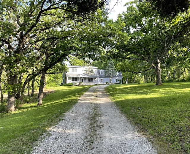 view of front of property with driveway and a front lawn