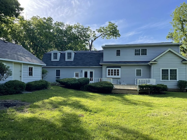 rear view of property with a lawn and a wooden deck