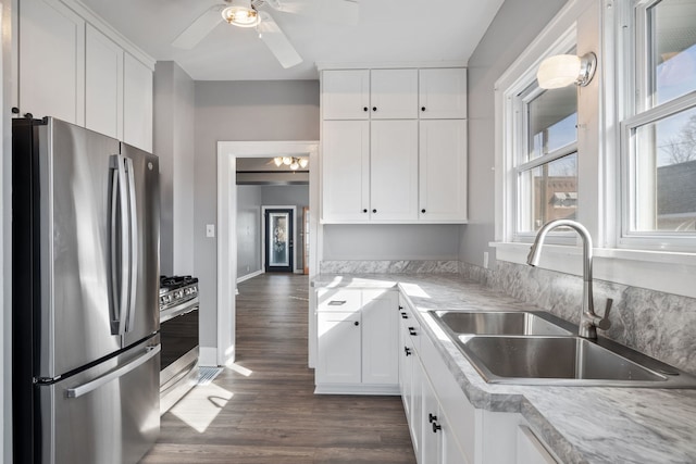 kitchen featuring a sink, appliances with stainless steel finishes, and white cabinetry