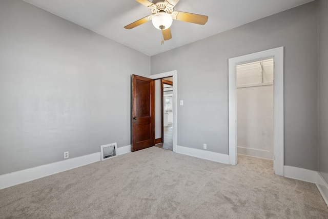 unfurnished bedroom featuring visible vents, baseboards, carpet, and a closet