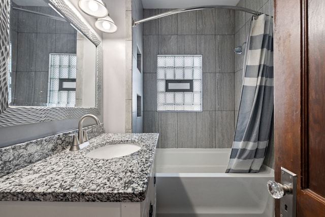 full bathroom featuring shower / bathtub combination with curtain and vanity