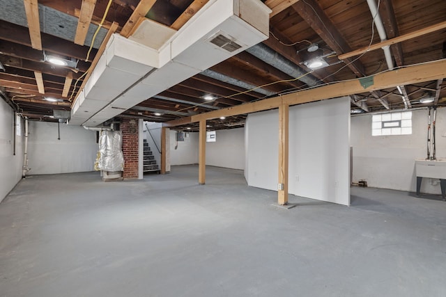 below grade area featuring visible vents, stairway, and a sink