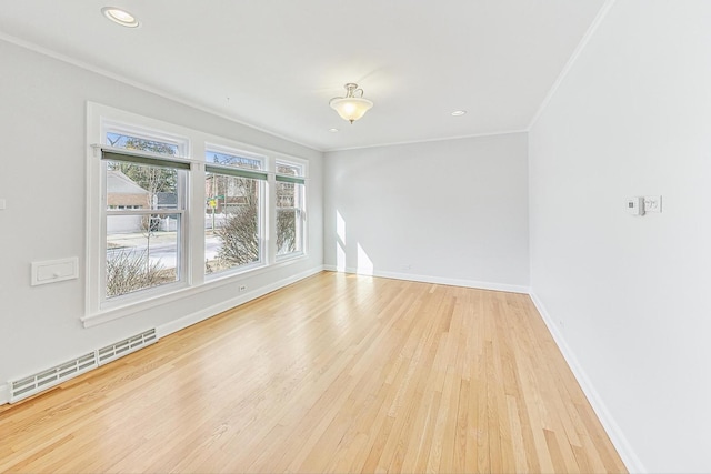 unfurnished room with wood finished floors, baseboards, recessed lighting, crown molding, and baseboard heating