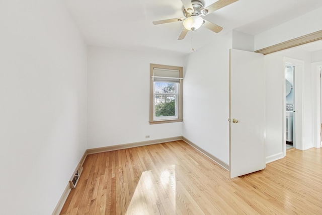 unfurnished bedroom featuring visible vents, baseboards, a ceiling fan, and light wood finished floors