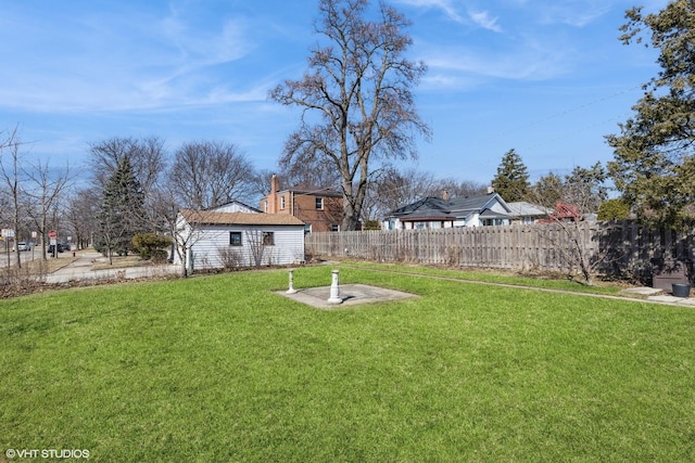 view of yard featuring an outbuilding and fence