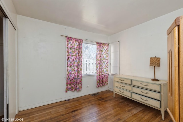 bedroom featuring visible vents and dark wood-type flooring