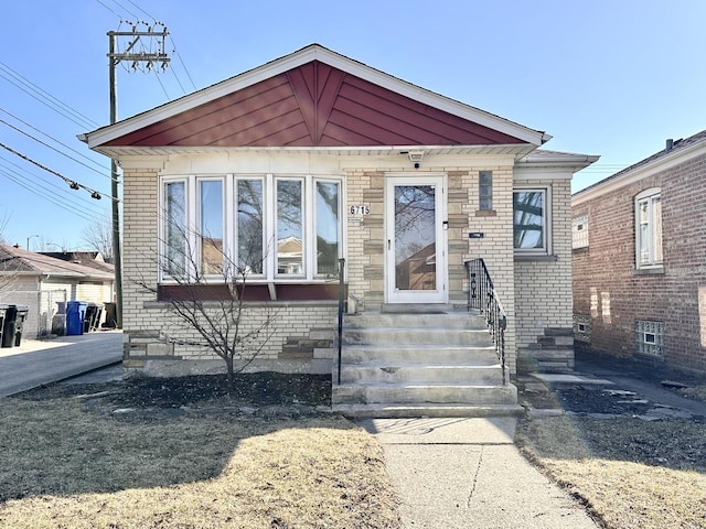 bungalow-style house with brick siding and entry steps