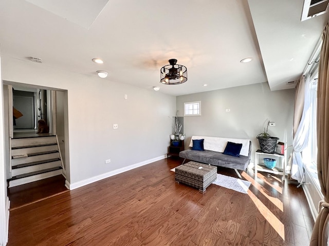 living area featuring visible vents, baseboards, stairway, recessed lighting, and dark wood-style flooring