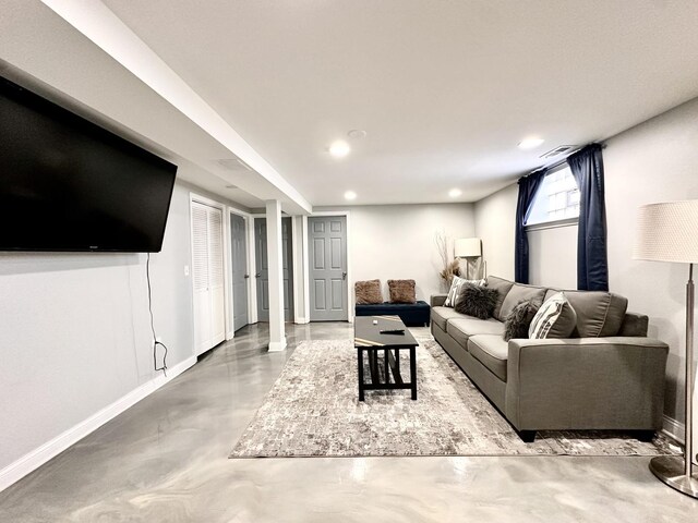 living area with recessed lighting, visible vents, baseboards, and concrete floors