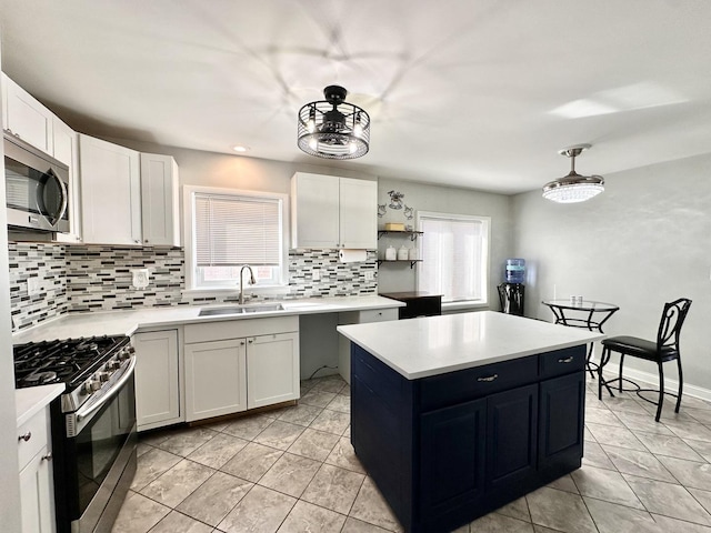 kitchen featuring a sink, open shelves, a center island, stainless steel appliances, and light countertops