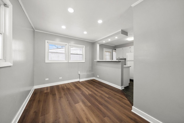 interior space with recessed lighting, baseboards, dark wood-style flooring, and crown molding