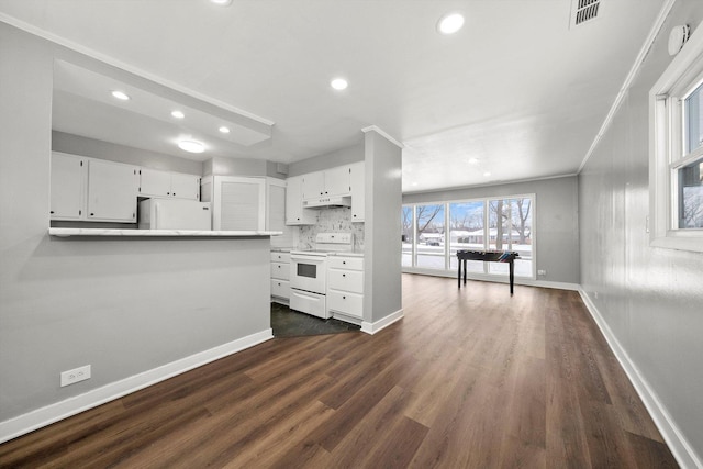 kitchen with under cabinet range hood, visible vents, white appliances, and white cabinets