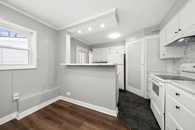 kitchen with a wealth of natural light, white appliances, and white cabinetry