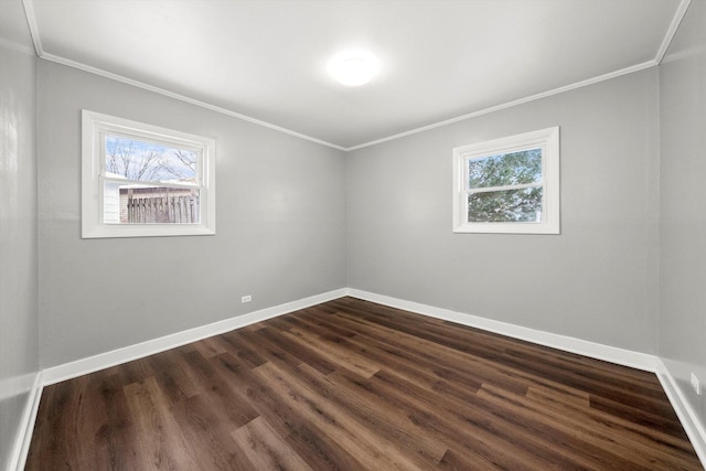 spare room with crown molding and baseboards