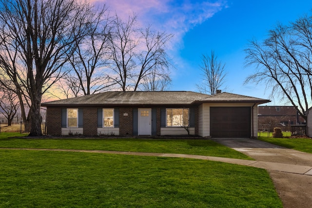 view of front of house featuring a garage, brick siding, concrete driveway, and a front yard