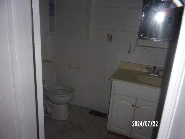 half bathroom featuring toilet and vanity