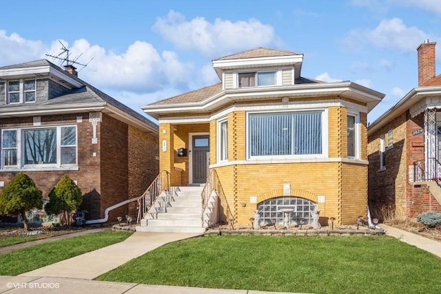 view of front facade with brick siding and a front yard