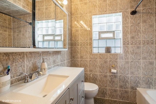 bathroom with toilet, a bathing tub, tile walls, walk in shower, and vanity