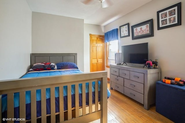 bedroom with a ceiling fan and light wood-style floors