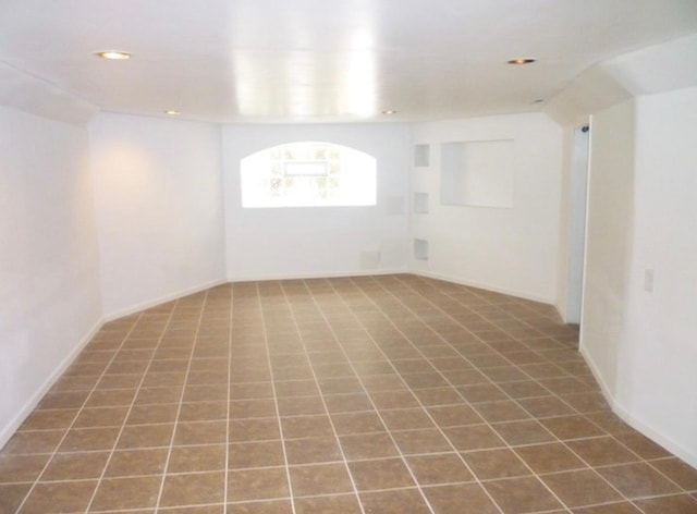 tiled spare room with recessed lighting and baseboards