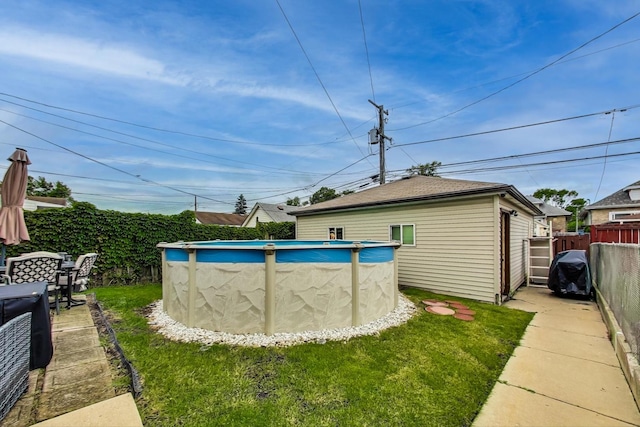 view of yard with a fenced in pool and fence