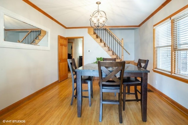 dining space featuring stairway, light wood-style floors, and ornamental molding