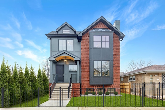 view of front of home with a fenced front yard, brick siding, and a front yard