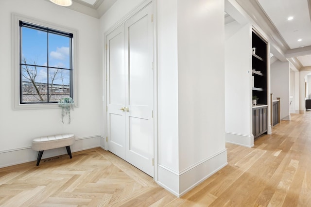 corridor with built in features, recessed lighting, and baseboards