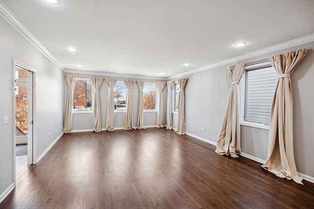 unfurnished room featuring baseboards, dark wood-type flooring, and ornamental molding