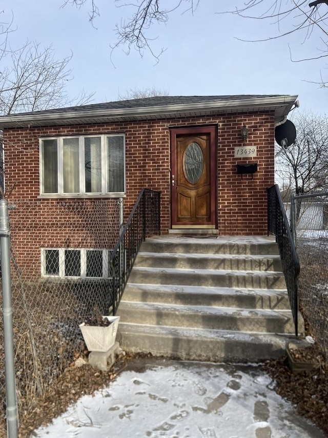 doorway to property with brick siding