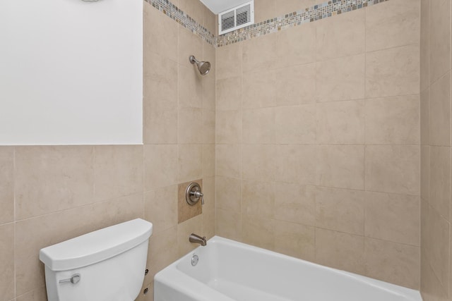 bathroom featuring toilet, visible vents, and shower / washtub combination