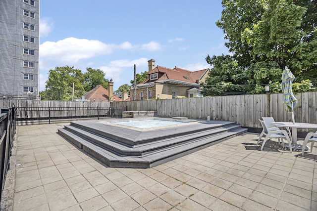 view of patio / terrace featuring a fenced backyard and a hot tub