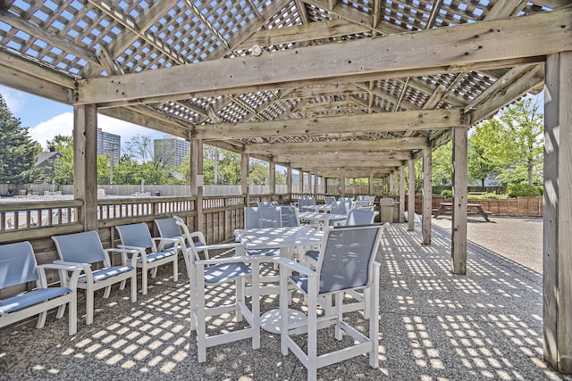 view of patio / terrace featuring outdoor dining space, fence, and a pergola