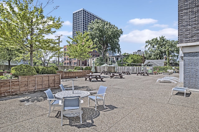 view of patio featuring a fire pit and fence