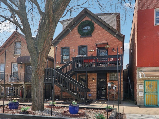 view of front of house with stairway and brick siding