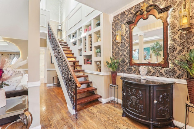 stairway featuring wood finished floors and baseboards