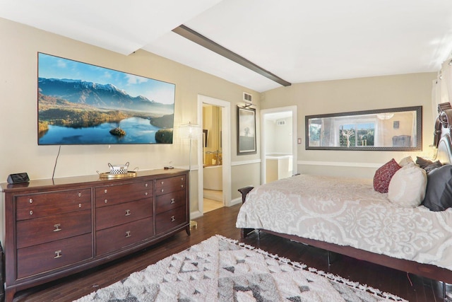 bedroom featuring visible vents, baseboards, dark wood-type flooring, and ensuite bathroom