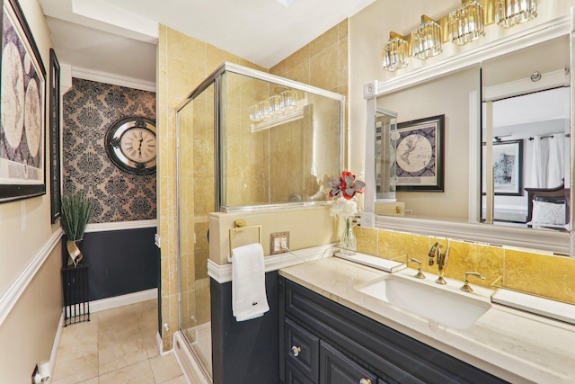 bathroom with a wainscoted wall, vanity, and a shower stall