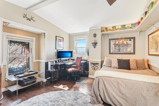 bedroom with lofted ceiling with beams, baseboards, and wood finished floors