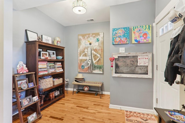 interior space featuring visible vents, baseboards, and wood finished floors